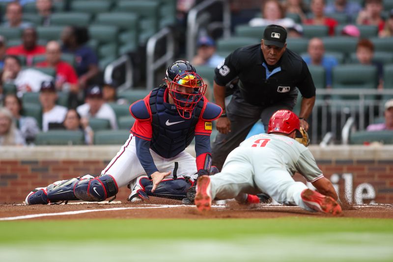 Jul 5, 2024; Atlanta, Georgia, USA; Atlanta Braves catcher Travis d'Arnaud (16) tags out Philadelphia Phillies second baseman Whit Merrifield (9) at home in the second inning at Truist Park. Mandatory Credit: Brett Davis-USA TODAY Sports
