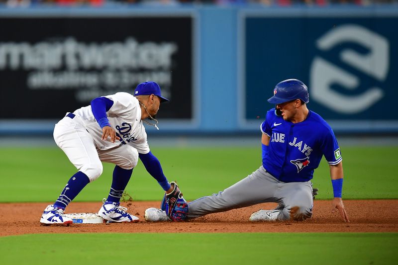 Jul 24, 2023; Los Angeles, California, USA; Toronto Blue Jays left fielder Daulton Varsho (25) is caught stealing second by Los Angeles Dodgers second baseman Mookie Betts (50) during the fourth inning at Dodger Stadium. Mandatory Credit: Gary A. Vasquez-USA TODAY Sports