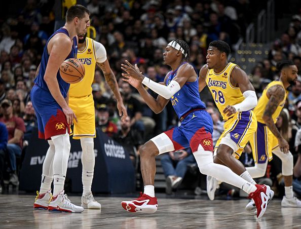 DENVER, CO - OCTOBER 24: Nikola Jokic (15) of the Denver Nuggets dumps the ball to Peyton Watson (8) as Rui Hachimura (28) of the Los Angeles Lakers defends during the third quarter at Ball Arena in Denver on Tuesday, October 24, 2023. (Photo by AAron Ontiveroz/The Denver Post)