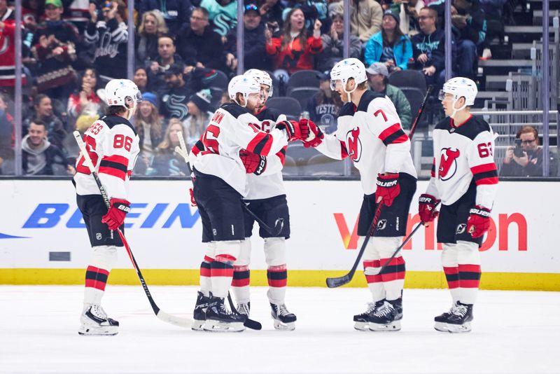 Jan 25, 2026; Seattle, Washington, USA; New Jersey Devils defenseman Dougie Hamilton (7) celebrates with New Jersey Devils right wing Connor Brown (16) after scoring a goal during the first period against the Seattle Kraken at Climate Pledge Arena. Mandatory Credit: Blake Dahlin-Imagn Images
