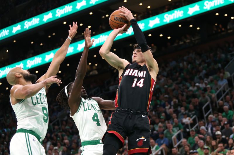 BOSTON, MASSACHUSETTS - OCTOBER 27: Tyler Herro #14 of the Miami Heat shoots over Derrick White #9 (L) and Jrue Holiday #4 of the Boston Celtics at TD Garden on October 27, 2023 in Boston, Massachusetts. NOTE TO USER: User expressly acknowledges and agrees that, by downloading and or using this photograph, User is consenting to the terms and conditions of the Getty Images License Agreement. (Photo by Maddie Schroeder/Getty Images)