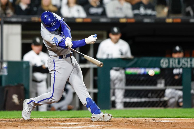 Sep 13, 2023; Chicago, Illinois, USA; Kansas City Royals shortstop Nick Loftin (12) hits an RBI-single against the Chicago White Sox during the seventh inning at Guaranteed Rate Field. Mandatory Credit: Kamil Krzaczynski-USA TODAY Sports