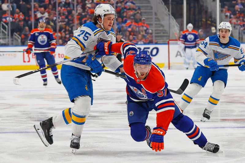 Jan 18, 2026; Edmonton, Alberta, CAN; St. Louis Blues defensemen Tyler Tucker (75) defends Edmonton Oilers forward Connor McDavid (97) during the third period at Rogers Place. Mandatory Credit: Perry Nelson-Imagn Images