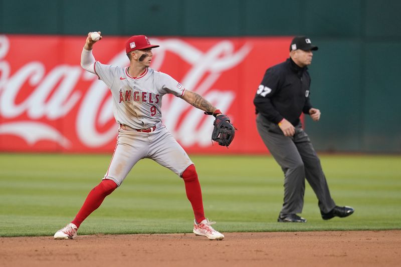 Jul 19, 2024; Oakland, California, USA; Los Angeles Angels shortstop Zach Neto (9) throws the ball to first to record an out against the Oakland Athletics in the fourth inning at Oakland-Alameda County Coliseum. Mandatory Credit: Cary Edmondson-USA TODAY Sports