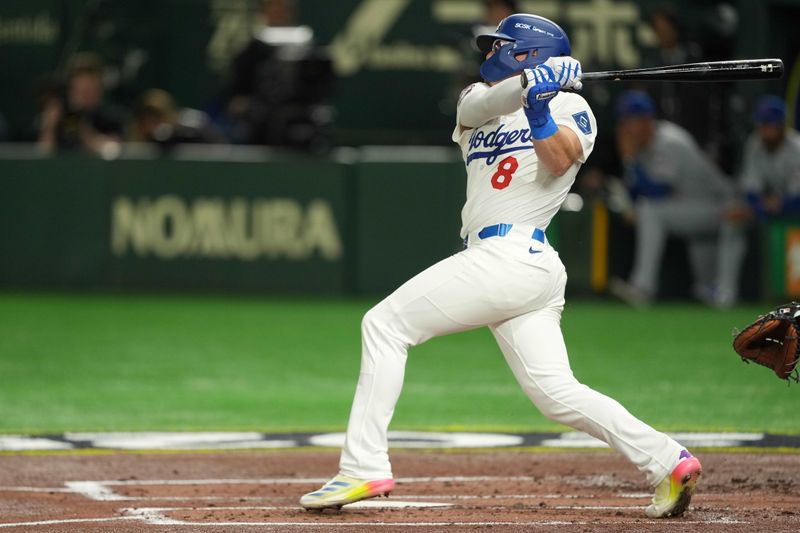 Mar 19, 2025; Bunkyo, Tokyo, JPN; Los Angeles Dodgers third baseman Enrique Hernández (8) hits an RBI sacrifice fly in the second inning against the Chicago Cubs during the Tokyo Series at Tokyo Dome. Mandatory Credit: Darren Yamashita-Imagn Images