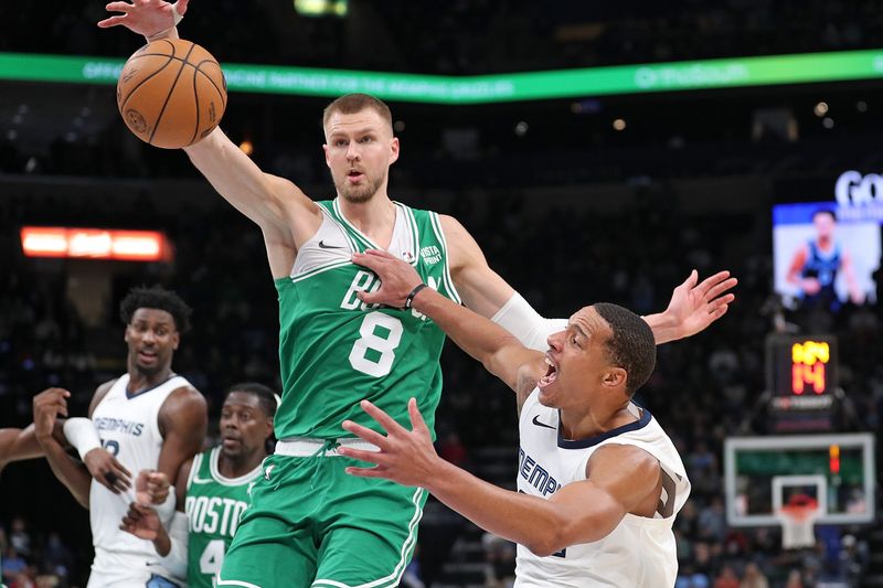 MEMPHIS, TENNESSEE - NOVEMBER 19: Desmond Bane #22 of the Memphis Grizzlies loses control of the ball during the second half against Kristaps Porzingis #8 of the Boston Celtics at FedExForum on November 19, 2023 in Memphis, Tennessee. NOTE TO USER: User expressly acknowledges and agrees that, by downloading and or using this photograph, User is consenting to the terms and conditions of the Getty Images License Agreement.  (Photo by Justin Ford/Getty Images)