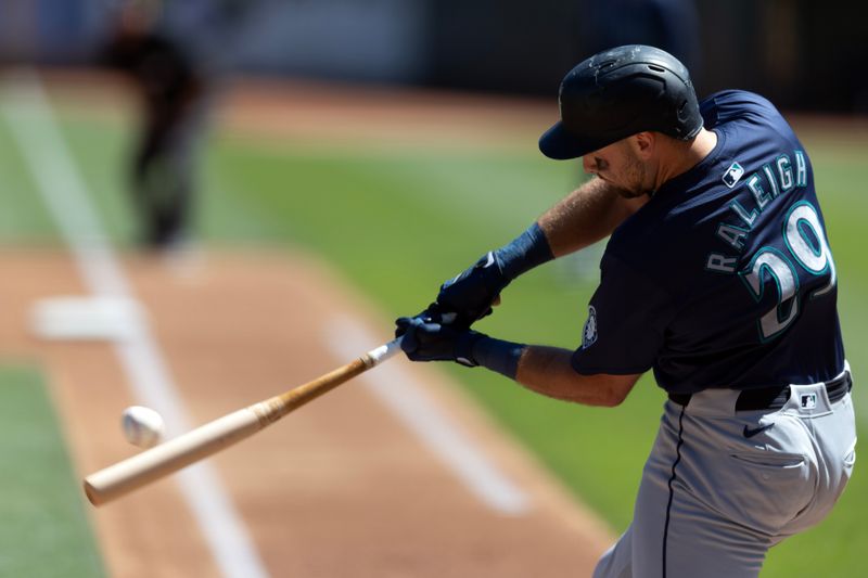 Sep 5, 2024; Oakland, California, USA; Seattle Mariners catcher Cal Raleigh (29) hits a two-run home run against the Oakland Athletics during the first inning at Oakland-Alameda County Coliseum. Mandatory Credit: D. Ross Cameron-Imagn Images