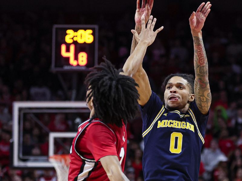 Feb 29, 2024; Piscataway, New Jersey, USA; Michigan Wolverines guard Dug McDaniel (0) shoots the ball asRutgers Scarlet Knights guard Noah Fernandes (2) defends during the first half at Jersey Mike's Arena. Mandatory Credit: Vincent Carchietta-USA TODAY Sports