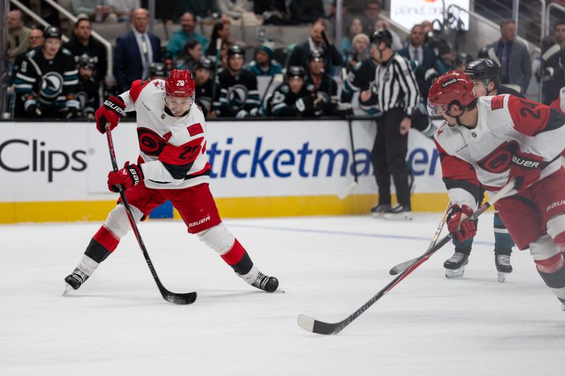 Oct 14, 2025; San Jose, California, USA;  Carolina Hurricanes center Sebastian Aho (20) shoots the puck during the first period against the San Jose Sharks at SAP Center at San Jose. Mandatory Credit: Stan Szeto-Imagn Images