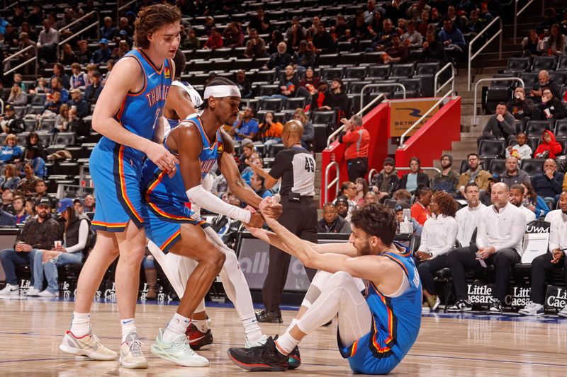 DETROIT, MI - JANUARY 28: Chet Holmgren #7 of the Oklahoma City Thunder is helped up by Shai Gilgeous-Alexander #2 during the game against the Detroit Pistons on January 28, 2024 at Little Caesars Arena in Detroit, Michigan. NOTE TO USER: User expressly acknowledges and agrees that, by downloading and/or using this photograph, User is consenting to the terms and conditions of the Getty Images License Agreement. Mandatory Copyright Notice: Copyright 2024 NBAE (Photo by Brian Sevald/NBAE via Getty Images)