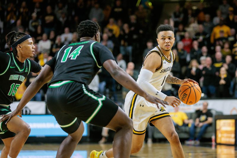 Jan 4, 2024; Wichita, Kansas, USA; Wichita State Shockers guard Xavier Bell (1) looks to get around North Texas Mean Green forward Moulaye Sissoko (14) during the first half at Charles Koch Arena. Mandatory Credit: William Purnell-USA TODAY Sports