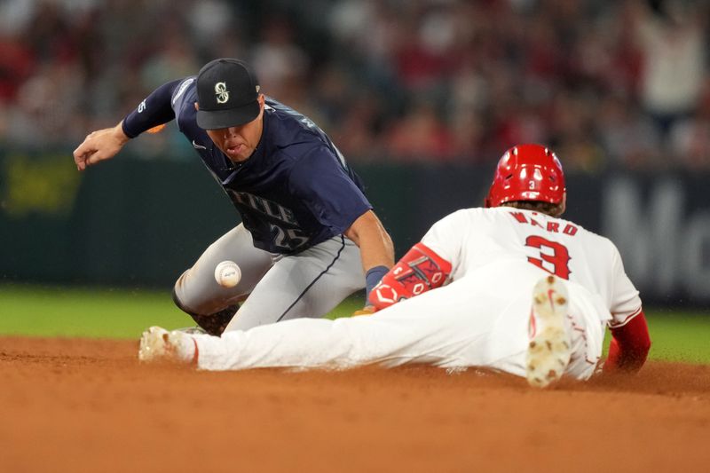 Aug 31, 2024; Anaheim, California, USA; Los Angeles Angels left fielder Taylor Ward (3) slides into second base on a double against Seattle Mariners second baseman Dylan Moore (25) in the eighth inning at Angel Stadium. Mandatory Credit: Kirby Lee-USA TODAY Sports