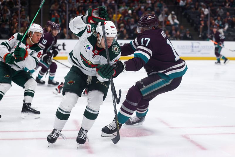 Mar 19, 2024; Anaheim, California, USA; Minnesota Wild center Marco Rossi (23) passes the puck through the legs of Anaheim Ducks left wing Alex Killorn (17) during the second period ofna game at Honda Center. Mandatory Credit: Jessica Alcheh-USA TODAY Sports