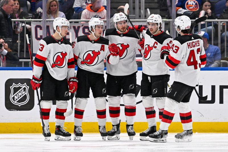 Mar 24, 2024; Elmont, New York, USA;  New Jersey Devils celebrate the goal by New Jersey Devils right wing Timo Meier (28) against the New York Islanders during the second period at UBS Arena. Mandatory Credit: Dennis Schneidler-USA TODAY Sports