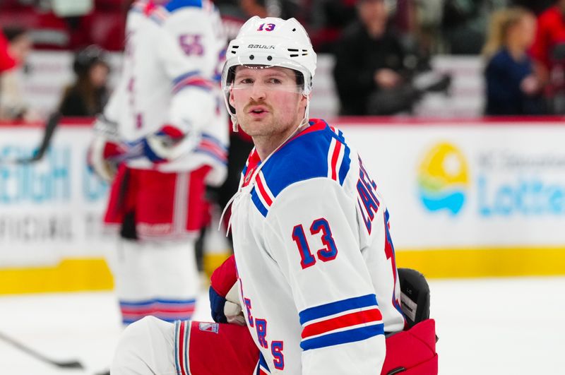 Nov 27, 2024; Raleigh, North Carolina, USA;  New York Rangers left wing Alexis Lafrenière (13) looks on during the warmups before the game against the Carolina Hurricanes at Lenovo Center. Mandatory Credit: James Guillory-Imagn Images