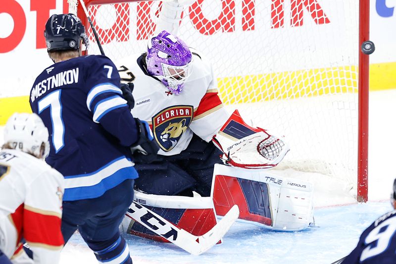 Nov 19, 2024; Winnipeg, Manitoba, CAN; Winnipeg Jets center Vladislav Namestnikov (7) shoots wide of Florida Panthers goaltender Sergei Bobrovsky (72)  in the third period at Canada Life Centre. Mandatory Credit: James Carey Lauder-Imagn Images