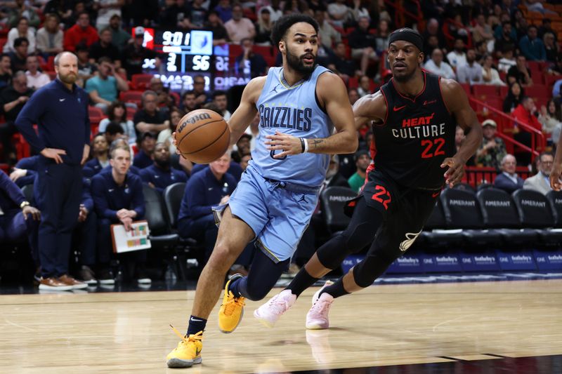 MIAMI, FLORIDA - JANUARY 24: Jacob Gilyard #0 of the Memphis Grizzlies drives past Jimmy Butler #22 of the Miami Heat during the third quarter of the game at Kaseya Center on January 24, 2024 in Miami, Florida. NOTE TO USER: User expressly acknowledges and agrees that, by downloading and or using this photograph, User is consenting to the terms and conditions of the Getty Images License Agreement. (Photo by Megan Briggs/Getty Images)