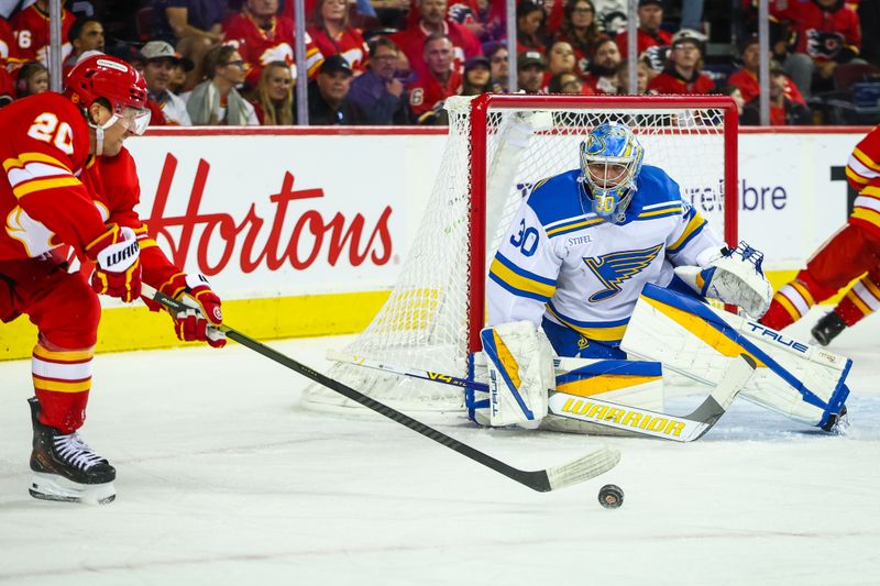 Oct 11, 2025; Calgary, Alberta, CAN; St. Louis Blues goaltender Joel Hofer (30) guards his net against Calgary Flames left wing Blake Coleman (20) during the second period at Scotiabank Saddledome. Mandatory Credit: Sergei Belski-Imagn Images