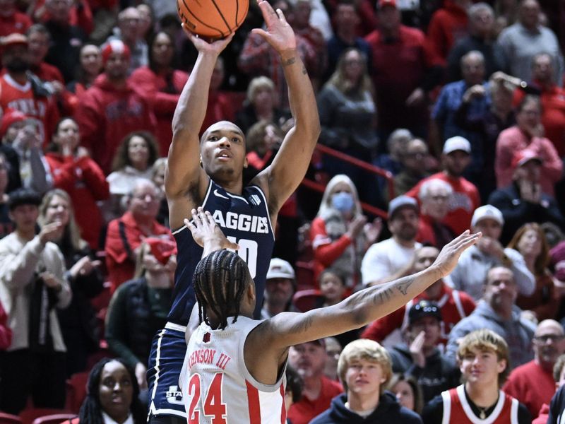 Jan 13, 2024; Las Vegas, Nevada, USA; Utah State Aggies guard Darius Brown II (10) scores on a three-point shot against UNLV Rebels guard Jackie Johnson III (24) in the second half at Thomas & Mack Center. Mandatory Credit: Candice Ward-USA TODAY Sports