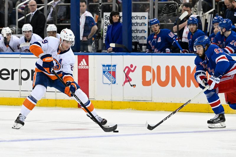 Apr 13, 2024; New York, New York, USA;  New York Islanders center Brock Nelson (29) skates with the puck defended by New York Rangers center Mika Zibanejad (93) during the third period at Madison Square Garden. Mandatory Credit: Dennis Schneidler-USA TODAY Sports