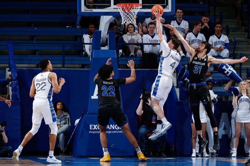 Mar 4, 2023; Colorado Springs, Colorado, USA; Air Force Falcons guard Carter Murphy (4) drives to the net against San Jose State Spartans forward Tibet Gorener (31) as forward Robert Vaihola (22) and forward Nikc Jackson (22) defend in the first half at Clune Arena. Mandatory Credit: Isaiah J. Downing-USA TODAY Sports