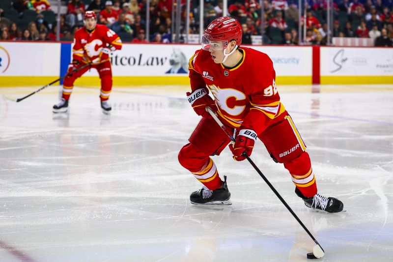 Mar 22, 2026; Calgary, Alberta, CAN; Calgary Flames right wing Matvei Gridin (92) controls the puck against the Tampa Bay Lightning during the second period at Scotiabank Saddledome. Mandatory Credit: Sergei Belski-Imagn Images