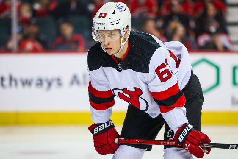 Dec 9, 2023; Calgary, Alberta, CAN; New Jersey Devils left wing Jesper Bratt (63) during the face off against the Calgary Flames during the third period at Scotiabank Saddledome. Mandatory Credit: Sergei Belski-USA TODAY Sports