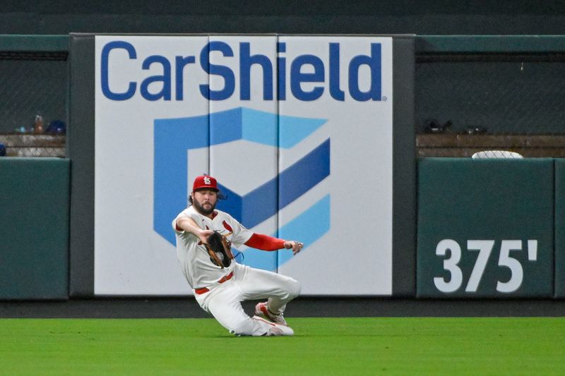 Jul 30, 2024; St. Louis, Missouri, USA;  St. Louis Cardinals left fielder Alec Burleson (41) dives and catches a line drive against the Texas Rangers during the ninth inning at Busch Stadium. Mandatory Credit: Jeff Curry-USA TODAY Sports