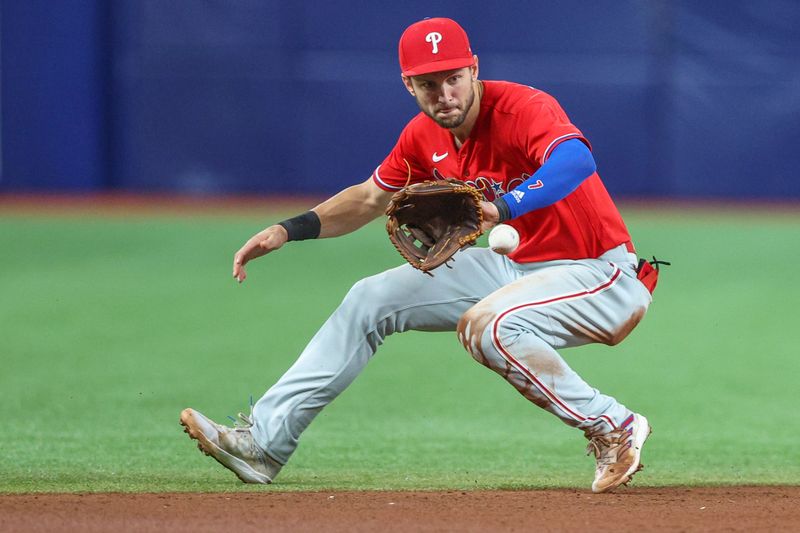 Jul 6, 2023; St. Petersburg, Florida, USA;  Philadelphia Phillies shortstop Trea Turner (7) fields the ball fro an out against the Tampa Bay Rays in the sixth inning at Tropicana Field. Mandatory Credit: Nathan Ray Seebeck-USA TODAY Sports