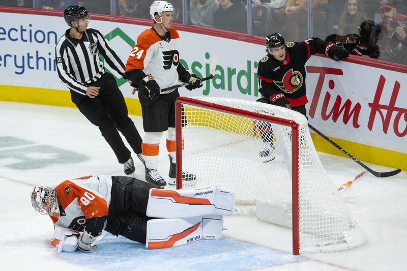 Oct 23, 2025; Ottawa, Ontario, CAN; Philadelphia Flyers defenseman Nick Seeler (24) draws a penallty for knocking Ottawa Senators center Ridly Greig (71) into Flyers goalie Dan Vladar (80) in the third period at the Canadian Tire Centre. Mandatory Credit: Marc DesRosiers-IMAGN Images