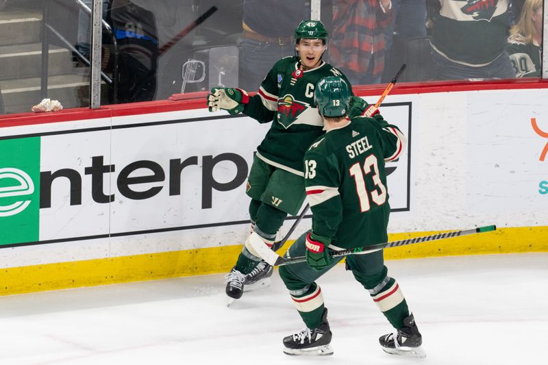 Apr 8, 2023; Saint Paul, Minnesota, USA; Minnesota Wild defenseman Jared Spurgeon (46) is congratulated by Minnesota Wild center Sam Steel (13) after scoring on the St. Louis Blues in the second period at Xcel Energy Center. Mandatory Credit: Matt Blewett-USA TODAY Sports