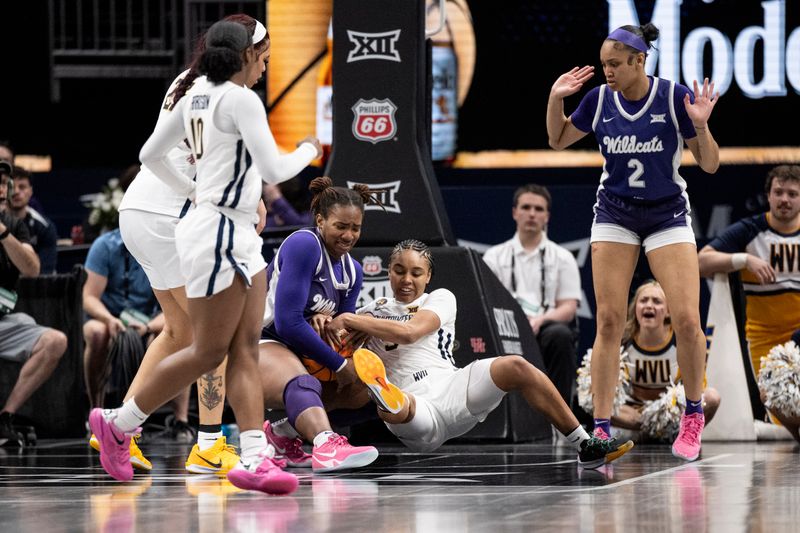 Mar 7, 2025; Kansas City, MO, USA; Kansas State Wildcats forward Kennedy Taylor (12) and West Virginia Mountaineers guard Sydney Shaw (5) fight for possession of the ball in the third quarter at T-Mobile Center. Mandatory Credit: Amy Kontras-Imagn Images