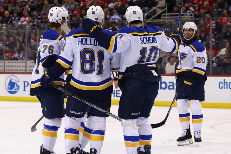 Nov 27, 2024; Newark, New Jersey, USA; St. Louis Blues center Dylan Holloway (81) celebrates his goal against the New Jersey Devils during the first period at Prudential Center. Mandatory Credit: Ed Mulholland-Imagn Images