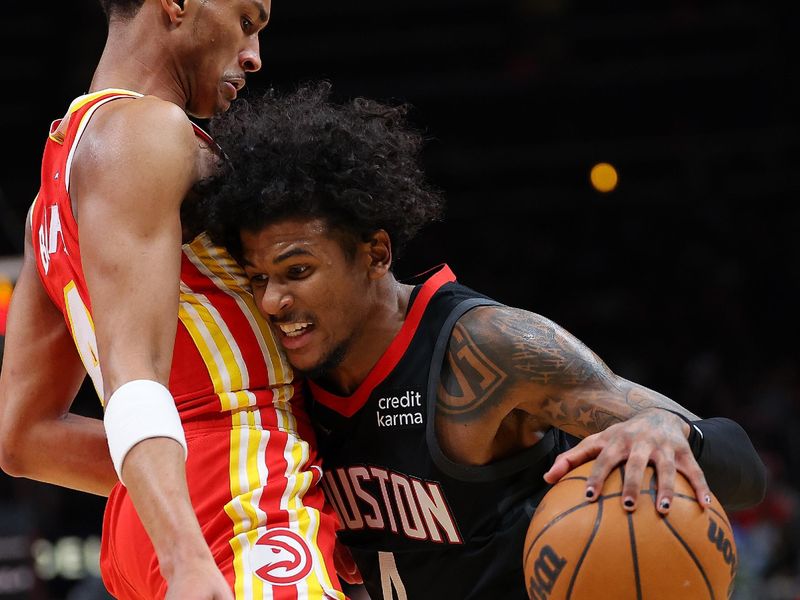 ATLANTA, GEORGIA - FEBRUARY 10:  Jalen Green #4 of the Houston Rockets draws a foul as he drives into Kobe Bufkin #4 of the Atlanta Hawks during the third quarter at State Farm Arena on February 10, 2024 in Atlanta, Georgia.  NOTE TO USER: User expressly acknowledges and agrees that, by downloading and/or using this photograph, user is consenting to the terms and conditions of the Getty Images License Agreement.  (Photo by Kevin C. Cox/Getty Images)