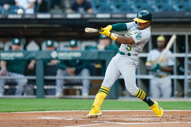 Aug 25, 2023; Chicago, Illinois, USA; Oakland Athletics second baseman Tony Kemp (5) hits a single against the Chicago White Sox during the second inning at Guaranteed Rate Field. Mandatory Credit: Kamil Krzaczynski-USA TODAY Sports