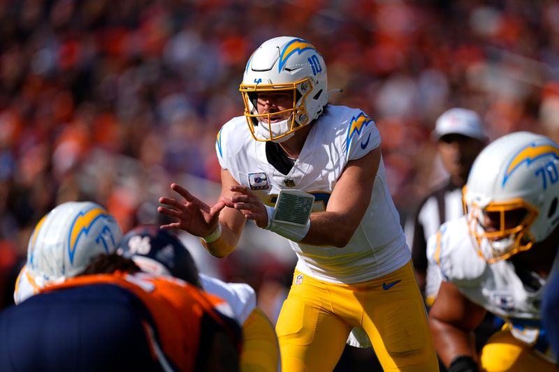 Los Angeles Chargers quarterback Justin Herbert (10) calls out plays during the first half of an NFL football game against the Denver Broncos, Sunday, Oct. 13, 2024, in Denver. (AP Photo/David Zalubowski)