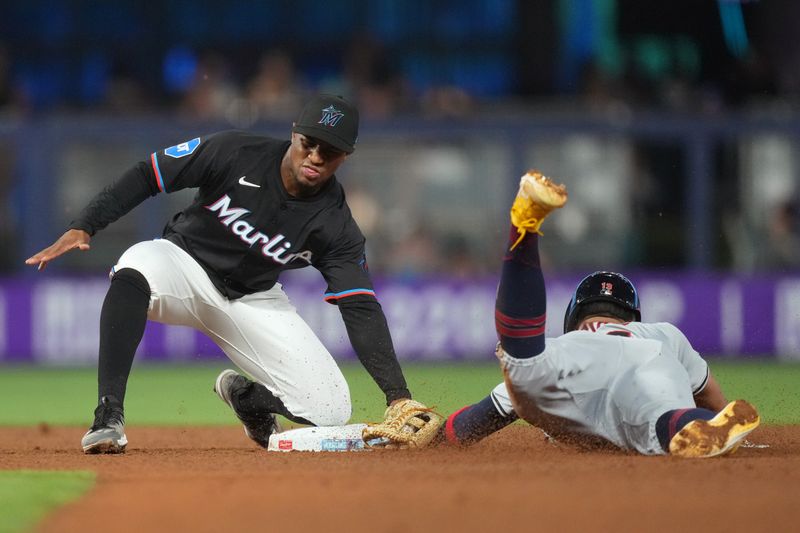 Jun 7, 2024; Miami, Florida, USA;  Cleveland Guardians third baseman Gabriel Arias (13) gets tagged out trying to steal second base by Miami Marlins shortstop Xavier Edwards (63) in the second inning at loanDepot Park. Mandatory Credit: Jim Rassol-USA TODAY Sports