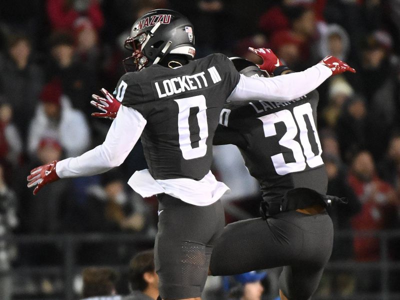 Nov 17, 2023; Pullman, Washington, USA; Washington State Cougars defensive back Sam Lockett III (0) and Washington State Cougars defensive back Jackson Lataimua (30) celebrate after a play against the Colorado Buffaloes in the first half at Gesa Field at Martin Stadium. Mandatory Credit: James Snook-USA TODAY Sports