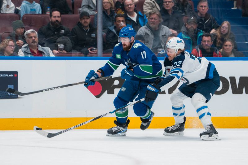 Mar 18, 2025; Vancouver, British Columbia, CAN; Winnipeg Jets forward Mason Appleton (22) stick checks Vancouver Canucks defenseman Filip Hronek (17) in the third period at Rogers Arena. Mandatory Credit: Bob Frid-Imagn Images