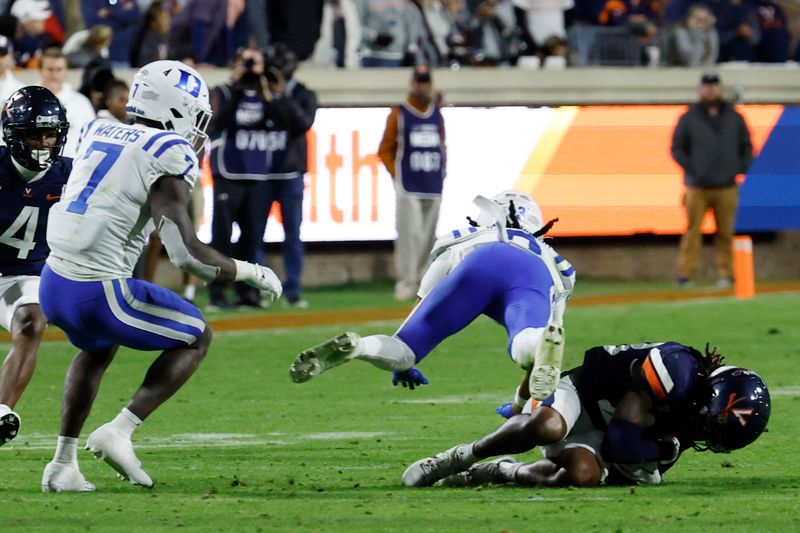 Nov 18, 2023; Charlottesville, Virginia, USA; Virginia Cavaliers cornerback Tayvonn Kyle (23) recovers an onside kick in front of Duke Blue Devils nose tackle Brandon Johnson (3) during final seconds of the fourth quarter at Scott Stadium. Mandatory Credit: Geoff Burke-USA TODAY Sports