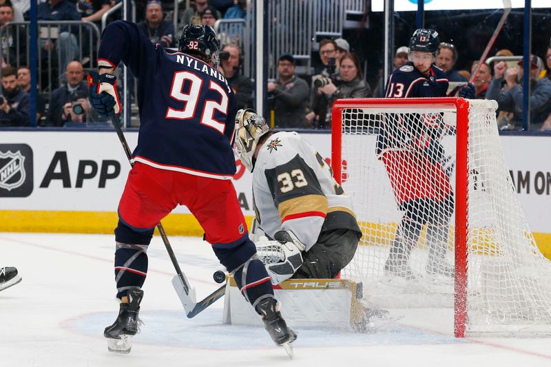 Mar 4, 2024; Columbus, Ohio, USA; Vegas Golden Knights goalie Adin Hill (33) makes a save as Columbus Blue Jackets left wing Alexander Nylander (92) looks for a rebound during the second period at Nationwide Arena. Mandatory Credit: Russell LaBounty-USA TODAY Sports