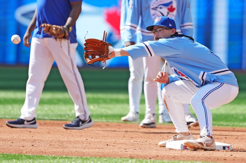 Aug 7, 2024; Toronto, Ontario, CAN; Toronto Blue Jays outfielder Davis Schneider (36) fields balls at second base during batting practice before a game against the Baltimore Orioles at Rogers Centre. Mandatory Credit: Nick Turchiaro-USA TODAY Sports