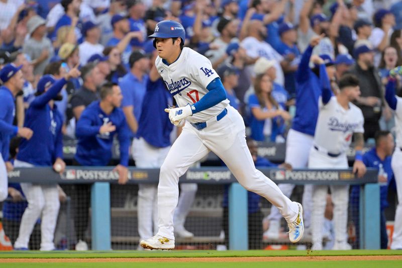 Oct 20, 2024; Los Angeles, California, USA; Los Angeles Dodgers designated hitter Shohei Ohtani (17) runs home to score after shortstop Tommy Edman (not pictured) hit a two RBI double in the first inning against the New York Mets during game six of the NLCS for the 2024 MLB playoffs at Dodger Stadium. Mandatory Credit: Jayne Kamin-Oncea-Imagn Images