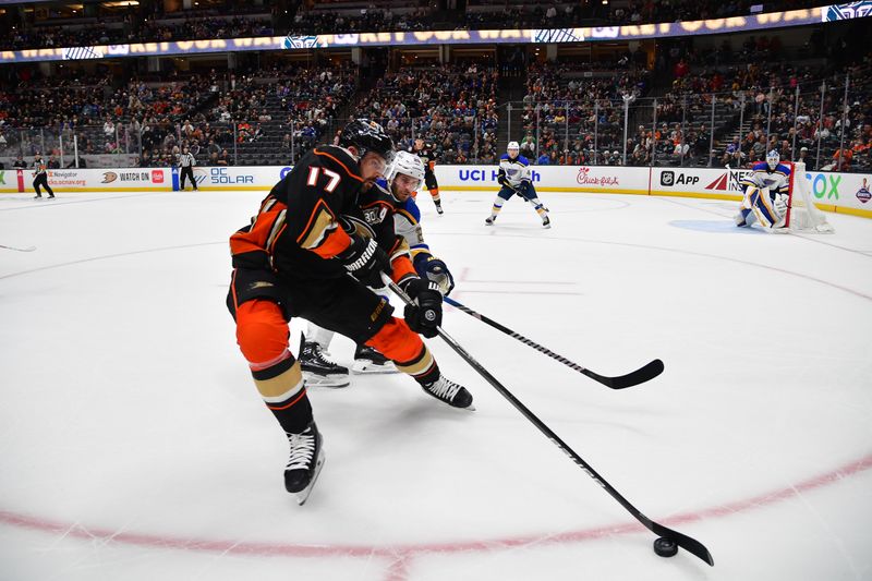 Apr 7, 2024; Anaheim, California, USA; Anaheim Ducks right wing Frank Vatrano (77) moves the puck against St. Louis Blues left wing Brandon Saad (20) during the overtime period at Honda Center. Mandatory Credit: Gary A. Vasquez-USA TODAY Sports