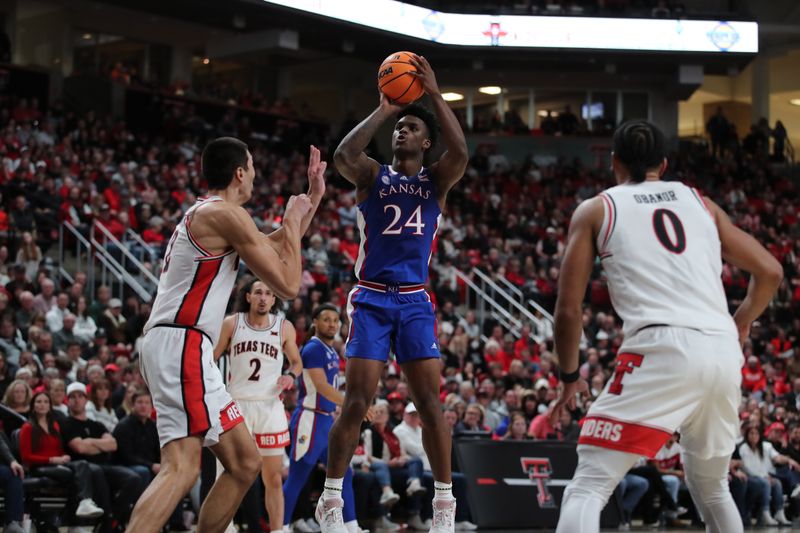 Jan 3, 2023; Lubbock, Texas, USA;  Kansas Jayhawks forward KJ Adams Jr (24) takes a jump shot over Texas Tech Red Raiders forward Daniel Batcho (12) in the second half at United Supermarkets Arena. Mandatory Credit: Michael C. Johnson-USA TODAY Sports