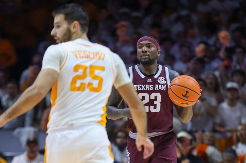 Feb 24, 2024; Knoxville, Tennessee, USA; Texas A&M Aggies guard Tyrece Radford (23) brings the ball up court against Tennessee Volunteers guard Santiago Vescovi (25) during the first half at Thompson-Boling Arena at Food City Center. Mandatory Credit: Randy Sartin-USA TODAY Sports