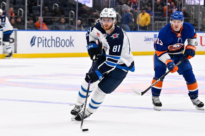 Mar 23, 2024; Elmont, New York, USA;  Winnipeg Jets left wing Kyle Connor (81) skates with the puck against the New York Islanders during the first period at UBS Arena. Mandatory Credit: Dennis Schneidler-USA TODAY Sports