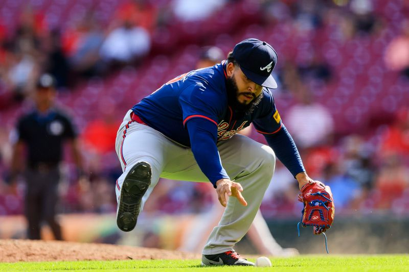 Sep 19, 2024; Cincinnati, Ohio, USA; Atlanta Braves relief pitcher Daysbel Hernandez (62) fields the ball hit by Cincinnati Reds catcher Luke Maile (not pictured) in the ninth inning at Great American Ball Park. Mandatory Credit: Katie Stratman-Imagn Images