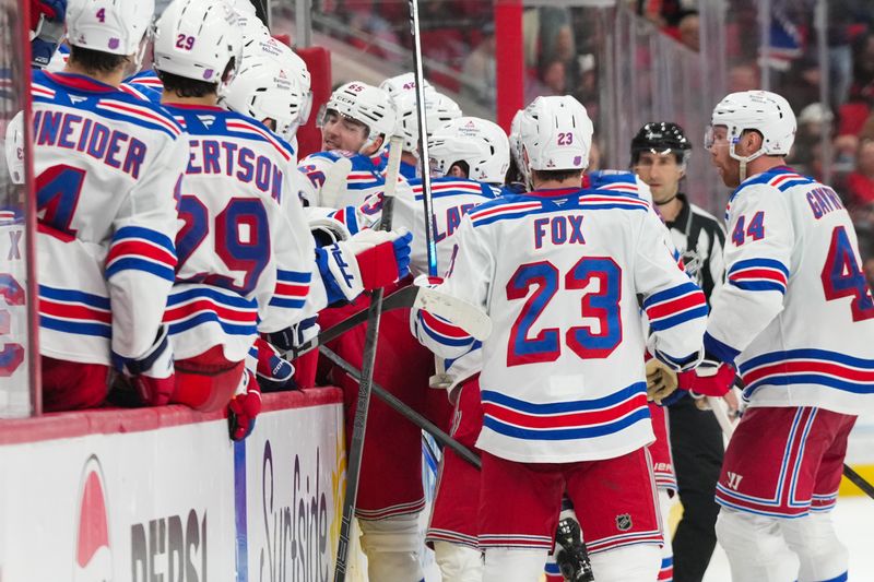 Nov 26, 2025; Raleigh, North Carolina, USA;  New York Rangers left wing Will Cuylle (50) celebrates with teammates after scoring an empty net goal against the Carolina Hurricanes during the third period at Lenovo Center. Mandatory Credit: James Guillory-Imagn Images