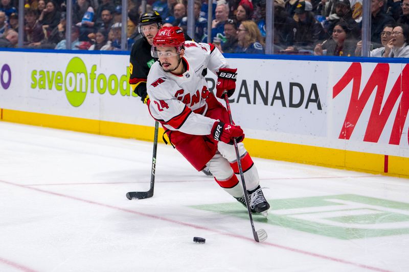 Oct 28, 2024; Vancouver, British Columbia, CAN; Carolina Hurricanes forward Seth Jarvis (24) handles the puck against the Vancouver Canucks during the second period at Rogers Arena. Mandatory Credit: Bob Frid-Imagn Images